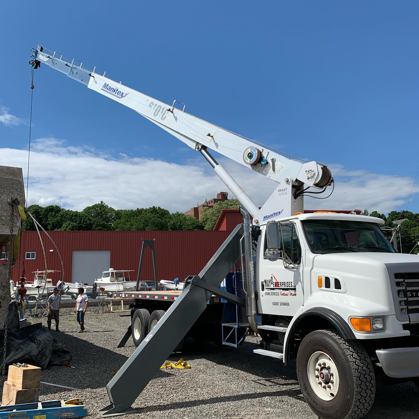 mayo enterprises crane on the waterfront portland maine moving a fishing boat